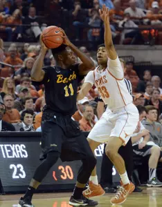 Dec 20, 2014; Austin, TX, USA; Texas Longhorns forward Jordan Barnett (33) defends against Long Beach State 49ers forward David Samuels (11) during the first half at the Frank Erwin Special Events Center. Mandatory Credit: Brendan Maloney-USA TODAY Sports