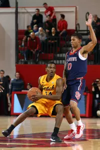Branford Jones controls the ball against St. John's Red Storm guard Jamal Branch. Brad Penner-USA TODAY Sports