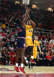 Travis Hammonds shoots over St. John's Red Storm forward Chris Obekpa. Brad Penner-USA TODAY Sports