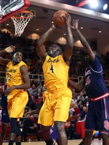 Temidayo Yussuf grabs a rebound in front of St. John's Red Storm guard Sir'Dominic Pointer. Brad Penner-USA TODAY Sports