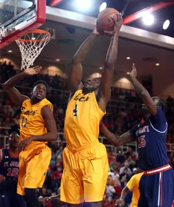 Temidayo Yussuf grabs a rebound in front of St. John's Red Storm guard Sir'Dominic Pointer. Brad Penner-USA TODAY Sports
