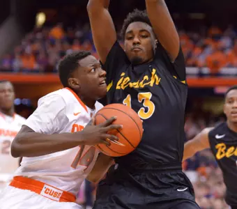 Dec 28, 2014; Syracuse, NY, USA; Syracuse Orange guard Christian White (13) looks to put a shot up with Long Beach State 49ers guard Deontae North (13) defending during the first half of a game at the Carrier Dome. Mandatory Credit: Mark Konezny-USA TODAY Sports