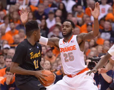 Dec 28, 2014; Syracuse, NY, USA; Long Beach State 49ers guard/forward Travis Hammonds (24) looks to put up a shot with Syracuse Orange forward Chris McCullough (5) defending during the first half of a game at the Carrier Dome. Mandatory Credit: Mark Konezny-USA TODAY Sports