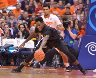 Dec 28, 2014; Syracuse, NY, USA; Long Beach State 49ers forward David Samuels (11) reaches for a loose ball during the first half of a game against the Syracuse Orange at the Carrier Dome. Syracuse won the game 85-67. Mandatory Credit: Mark Konezny-USA TODAY Sports