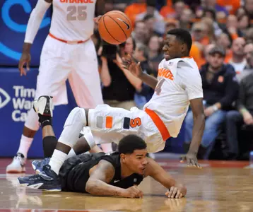 Dec 28, 2014; Syracuse, NY, USA; Syracuse Orange guard Kaleb Joseph (14) is tripped while going for a loose ball by Long Beach State 49ers guard/forward Travis Hammonds (24) during the second half of a game at the Carrier Dome. Mandatory Credit: Mark Konezny-USA TODAY Sports