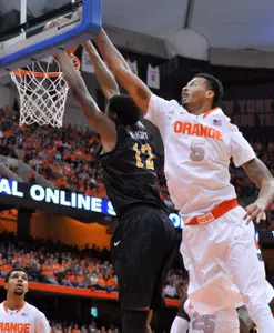 Dec 28, 2014; Syracuse, NY, USA; Syracuse Orange forward Chris McCullough (5) attempts a dunk against Long Beach State 49ers forward Eric McKnight (12) during the first half of a game at the Carrier Dome. Syracuse won the game 85-67. Mandatory Credit: Mark Konezny-USA TODAY Sports