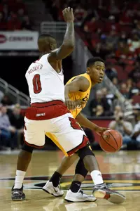 Dec 30, 2014; Louisville, KY, USA; Long Beach State 49ers guard Mike Caffey (5) dribbles against Louisville Cardinals guard Terry Rozier (0) during the first half at KFC Yum! Center. Mandatory Credit: Jamie Rhodes-USA TODAY Sports