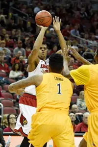 Dec 30, 2014; Louisville, KY, USA; Louisville Cardinals guard/forward Wayne Blackshear (25) shoots against Long Beach State 49ers guard Tyler Lamb (1) during the first half at KFC Yum! Center. Mandatory Credit: Jamie Rhodes-USA TODAY Sports