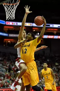 Dec 30, 2014; Louisville, KY, USA; Long Beach State 49ers forward Eric McKnight (12) shoots against Louisville Cardinals forward Anas Mahmoud (14) during the first half at KFC Yum! Center. Mandatory Credit: Jamie Rhodes-USA TODAY Sports