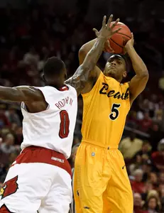 Dec 30, 2014; Louisville, KY, USA; Long Beach State 49ers guard Mike Caffey (5) shoots against Louisville Cardinals guard Terry Rozier (0) during the first half at KFC Yum! Center. Mandatory Credit: Jamie Rhodes-USA TODAY Sports