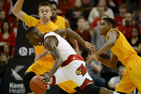 Dec 30, 2014; Louisville, KY, USA; Louisville Cardinals guard Terry Rozier (0) dribbles against Long Beach State 49ers forward Jack Williams (35) during the first half at KFC Yum! Center. Mandatory Credit: Jamie Rhodes-USA TODAY Sports