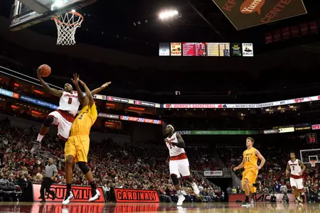Dec 30, 2014; Louisville, KY, USA; Louisville Cardinals guard Terry Rozier (0) shoots against Long Beach State 49ers forward Eric McKnight (12) during the second half at KFC Yum! Center. Louisvile defeated Long Beach State 63-48. Mandatory Credit: Jamie Rhodes-USA TODAY Sports