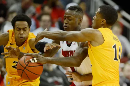 Dec 30, 2014; Louisville, KY, USA; Louisville Cardinals guard Terry Rozier (0) scrambles for a loose ball with Long Beach State 49ers guard Justin Bibbins (21) and guard Branford Jones (14) during the second half at KFC Yum! Center. Louisvile defeated Long Beach State 63-48.  Mandatory Credit: Jamie Rhodes-USA TODAY Sports