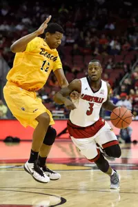Dec 30, 2014; Louisville, KY, USA; Louisville Cardinals guard Chris Jones (3) dribbles against Long Beach State 49ers forward Eric McKnight (12) during the second half at KFC Yum! Center. Louisvile defeated Long Beach State 63-48. Mandatory Credit: Jamie Rhodes-USA TODAY Sports