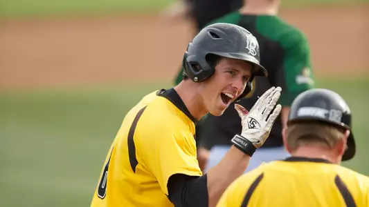 Senior Michael Hill celebrates a triple in last week's 4-1 win over Wright State.