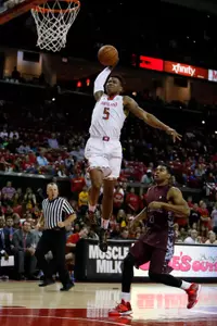 Dec 31, 2013; College Park, MD, USA; Maryland Terrapins guard Nick Faust (5) dunks over NC Central Eagles guard Dante Holmes (0) at Comcast Center. Mandatory Credit: Mitch Stringer-USA TODAY Sports