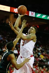 Dec 31, 2013; College Park, MD, USA; Maryland Terrapins guard Nick Faust (5) dunks over NC Central Eagles guard Dante Holmes (0) at Comcast Center. Mandatory Credit: Mitch Stringer-USA TODAY Sports