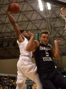 Nov 16, 2015; Long Beach, CA, USA; Long Beach State 49ers guard Nick Faust (left) dunks the ball in front of Brigham Young Cougars guard Kyle Collinsworth (right) during the second half at The Pyramid. The Long Beach State 49ers won 66-65. Mandatory Credit: Kelvin Kuo-USA TODAY Sports