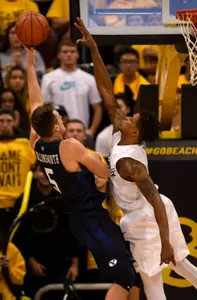 Nov 16, 2015; Long Beach, CA, USA; Brigham Young Cougars guard Kyle Collinsworth (left) attempts a shot defended by Long Beach State 49ers guard Nick Faust (right) during the second half at The Pyramid. The Long Beach State 49ers won 66-65. Mandatory Credit: Kelvin Kuo-USA TODAY Sports