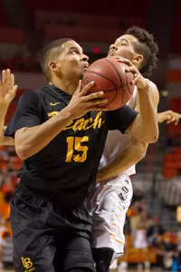 Long Beach State 49ers guard A.J. Spencer (15) prepares to shoot the ball around Oklahoma State Cowboys guard Jeffrey Carroll (30) during the first quarter at Gallagher-Iba Arena.