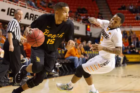 Long Beach State 49ers guard A.J. Spencer (15) dribbles the ball as Oklahoma State Cowboys guard Tyree Griffin (2) defends during the first quarter at Gallagher-Iba Arena.