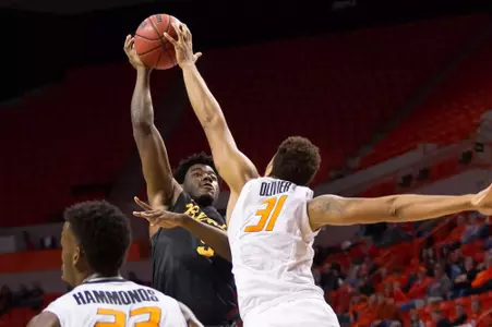 Long Beach State 49ers forward Mason Riggins (5) shoots the ball as Oklahoma State Cowboys forward Chris Olivier (31) defends during the first half at Gallagher-Iba Arena.