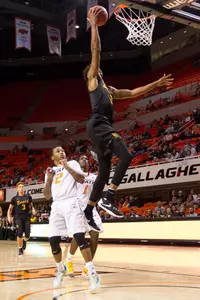 Long Beach State 49ers guard Nick Faust (2) shoots the ball as Oklahoma State Cowboys guard Tyree Griffin (2) defends during the first half at Gallagher-Iba Arena.