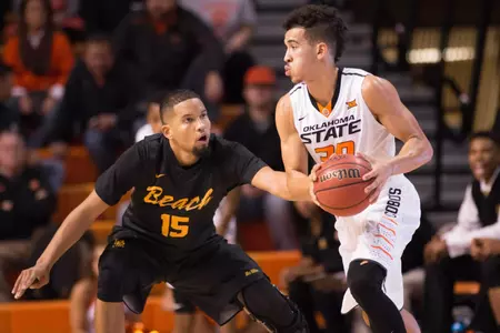 Oklahoma State Cowboys guard Jeffrey Carroll (30) looks to pass the ball as Long Beach State 49ers guard A.J. Spencer (15) defends during the first half at Gallagher-Iba Arena.