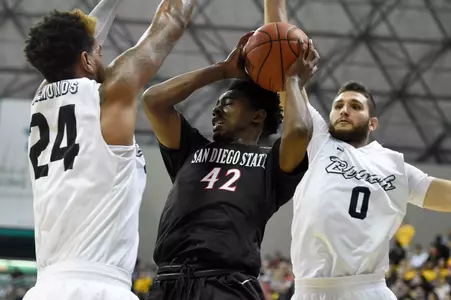 Dec 1, 2015; Long Beach, CA, USA; San Diego State Aztecs guard Jeremy Hemsley (42) drives the ball defended by Long Beach State 49ers guard Travis Hammonds (24) and Long Beach State 49ers forward Gabe Levin (0) during the first half at The Pyramid. Mandatory Credit: Kelvin Kuo-USA TODAY Sports