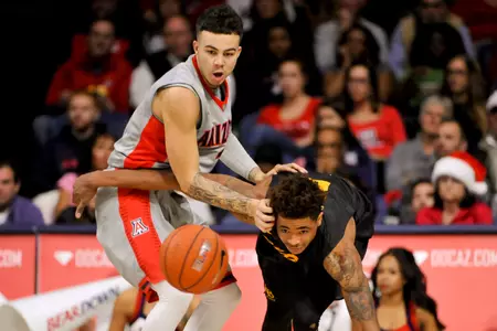 Arizona Wildcats guard Gabe York and 49ers guard Nick Faust go after the ball during the first half at McKale Center. Credit: Casey Sapio-USA TODAY Sports