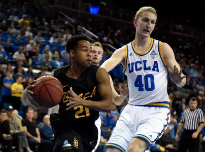 49ers guard Justin Bibbins drives to the basket against UCLA Bruins center Thomas Welsh during the game at Pauley Pavilion. Credit: Richard Mackson-USA TODAY Sports