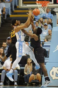 North Carolina Tar Heels forward Isaiah Hicks (4) and Long Beach State 49ers forward Roschon Prince (23) and forward Temidayo Yussuf (4) go for a rebound during the first half at Dean E. Smith Center. Evan Pike-USA TODAY Sports