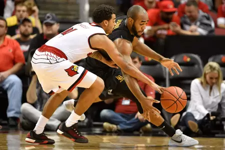 Louisville Cardinals guard Quentin Snider (4) scrambles for a loose ball with Long Beach State 49ers forward Roschon Prince (23) during the second half at KFC Yum! Center. Jamie Rhodes-USA TODAY Sports