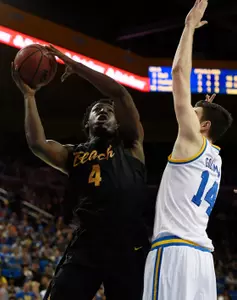 Nov 20, 2016; Los Angeles, CA, USA; Long Beach State 49ers forward Temidayo Yussuf (4) attempts a shot defended by UCLA Bruins forward Gyorgy Goloman (14). Kelvin Kuo-USA TODAY Sports