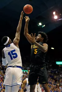 49ers forward Mason Riggins (5) shoots as Kansas Jayhawks forward Carlton Bragg Jr. (15) defends. Jay Biggerstaff-USA TODAY Sports