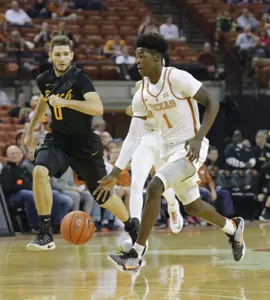 Dec 10, 2016; Austin, TX, USA; Texas Longhorns guard Andrew Jones (1) dribbles the ball past Long Beach State 49ers forward Gabe Levin (0). Sean Pokorny-USA TODAY Sports