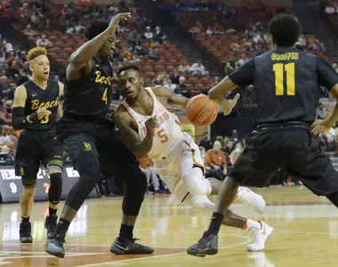 Dec 10, 2016; Austin, TX, USA; Texas Longhorns guard Kendal Yancy (5) dribbles the ball against Long Beach State 49ers forward Temidayo Yussuf (4). Sean Pokorny-USA TODAY Sports