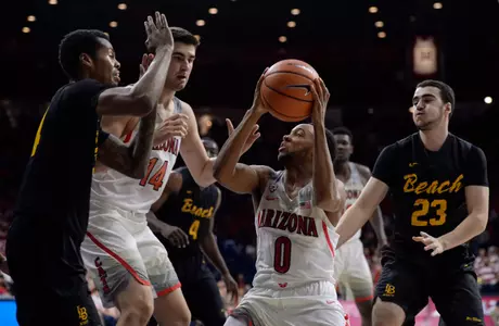 Nov 29, 2017; Tucson, AZ, USA; Arizona Wildcats guard Parker Jackson-Cartwright (0) looks to shoot the ball as Long Beach State 49ers guard KJ Byers (left) and guard Edon Maxhuni (23) defend during the second half at McKale Center. Mandatory Credit: Casey Sapio-USA TODAY Sports