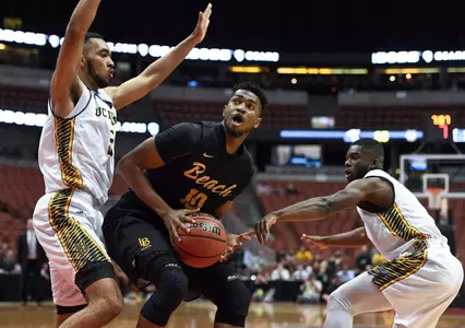 Mar 10, 2017; Anaheim, CA, USA; Long Beach State 49ers forward Quentin Shropshire (10) drives to the basket defended by UC Irvine Anteaters forward Jonathan Galloway (5) and UC Irvine Anteaters guard Max Hazzard (2). Robert Hanashiro-USA TODAY Sports