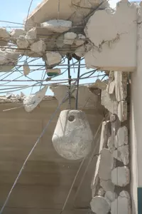 The wrecking ball dangles through the demolished Fouts eastside stands