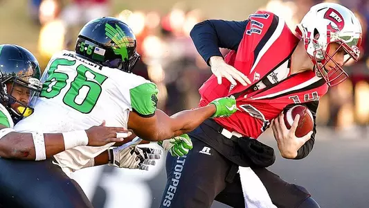 North Texas defensive lineman Malik Dilonga tries to bring down WKU quarterback Mike White. (photo by Manny Flores)
