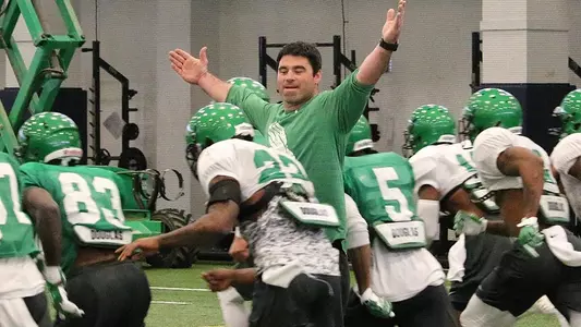 Head coach Seth Littrell and his Mean Green conduct practice at Highland Park High School's indoor facility.