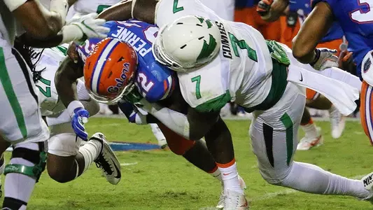 North Texas defensive end Jareid Combs stops a Florida running back Saturday night at Ben Hill Griffin Stadium (photo by David Pyke).