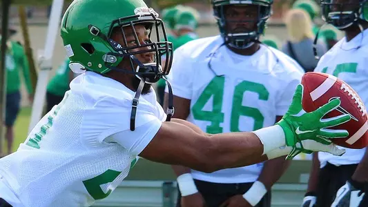 Freshman Tyreke Davis, from Denton Ryan High School, stretches to make a catch in drills in his first Mean Green practice Monday morning (photo by David Pyke).