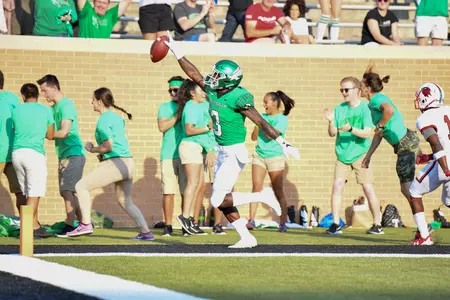 Jeffery Wilson celebrates one of his three touchdowns in Saturday night's season opener (photo by Rick Yeatts)