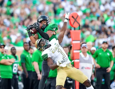 Jalen Guyton catches a pass over a UAB defender for a 47-yard touchdown Saturday night. (photo by Manny Flores/Rick Yeatts)