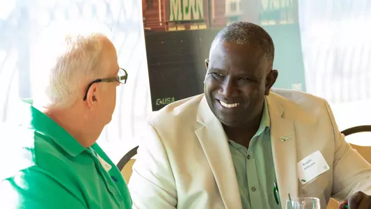 MGSF staff member Reggie Johnson meets with a Mean Green fan