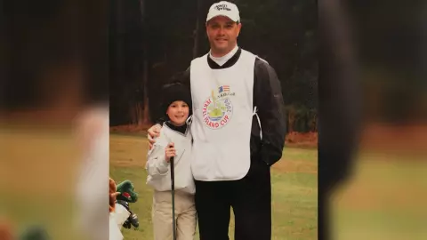 Golfer (Sean Wilcox) as a child standing with another golfer on a golf course