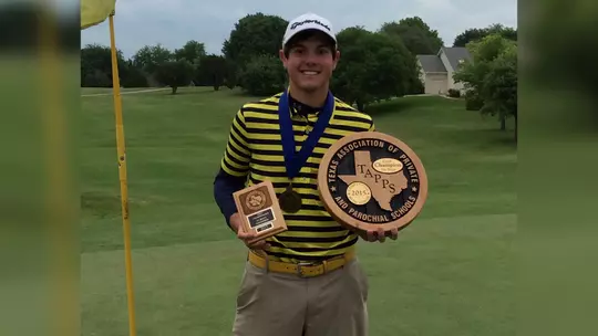 Golfer (Sean Wilcox) holding championship awards on a golf course