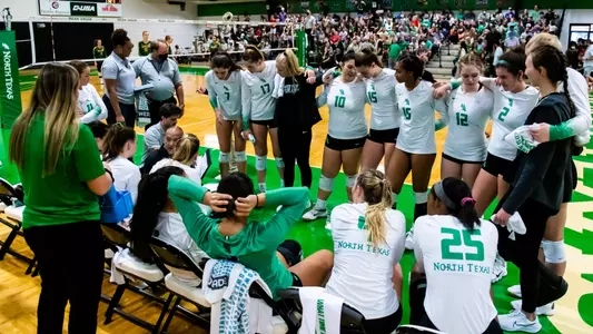 Mean Green volleyball team listens in during a timeout